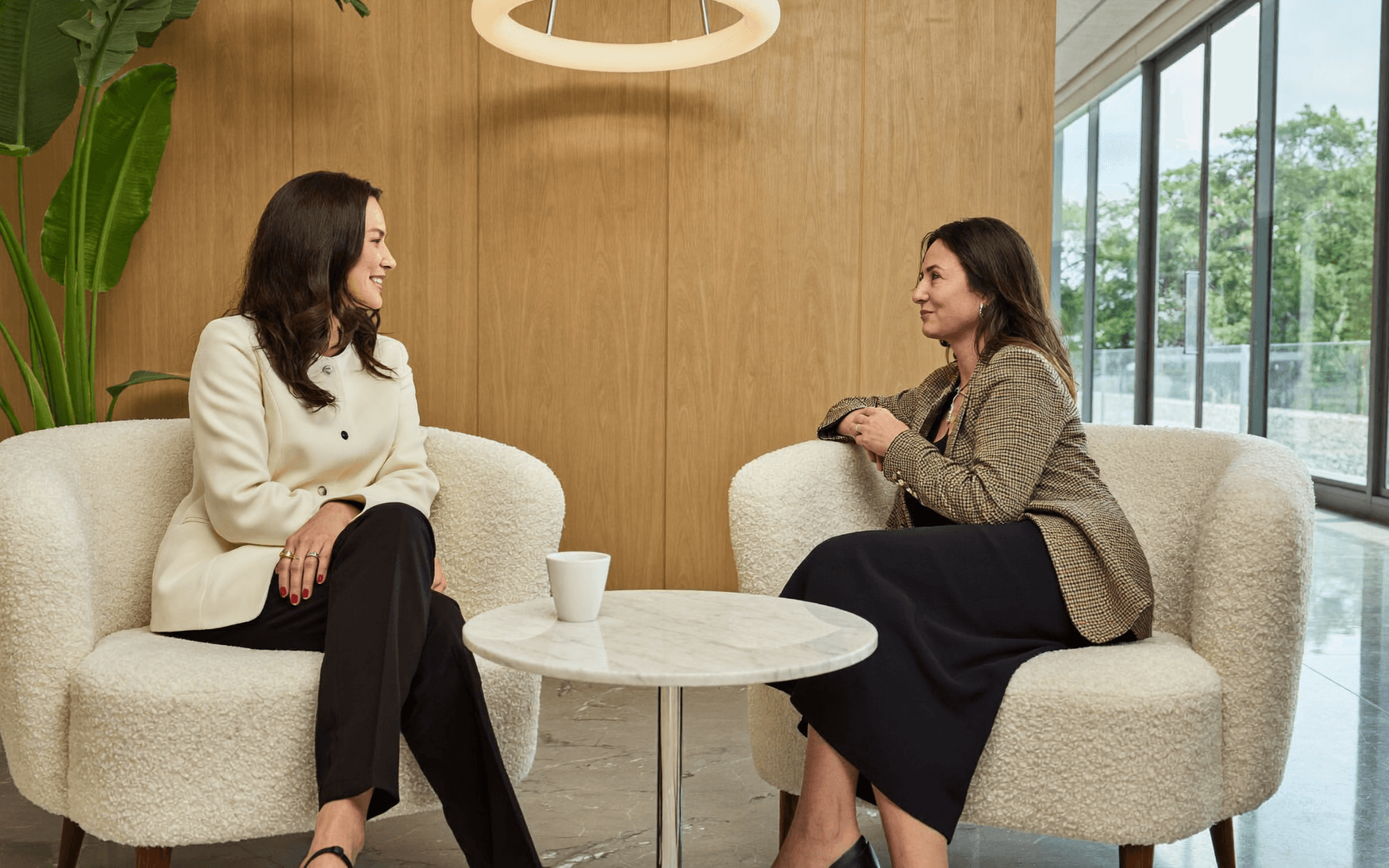 A treatment coordinator and a patient talking in a cosmetic dental practice lounge