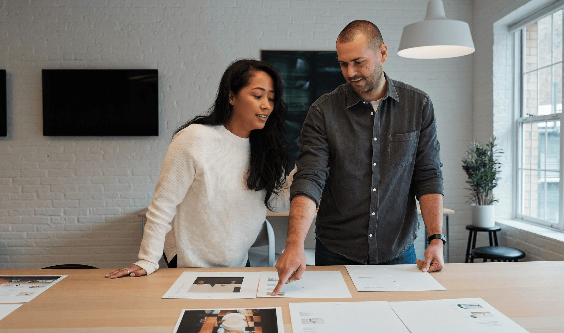 An agency team reviewing work together